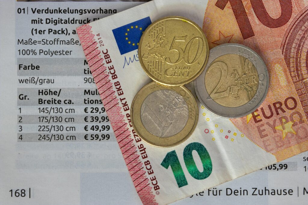 pexels photo 10356910 10356910 Euro coins and bills on a price list, symbolizing finance and economy.