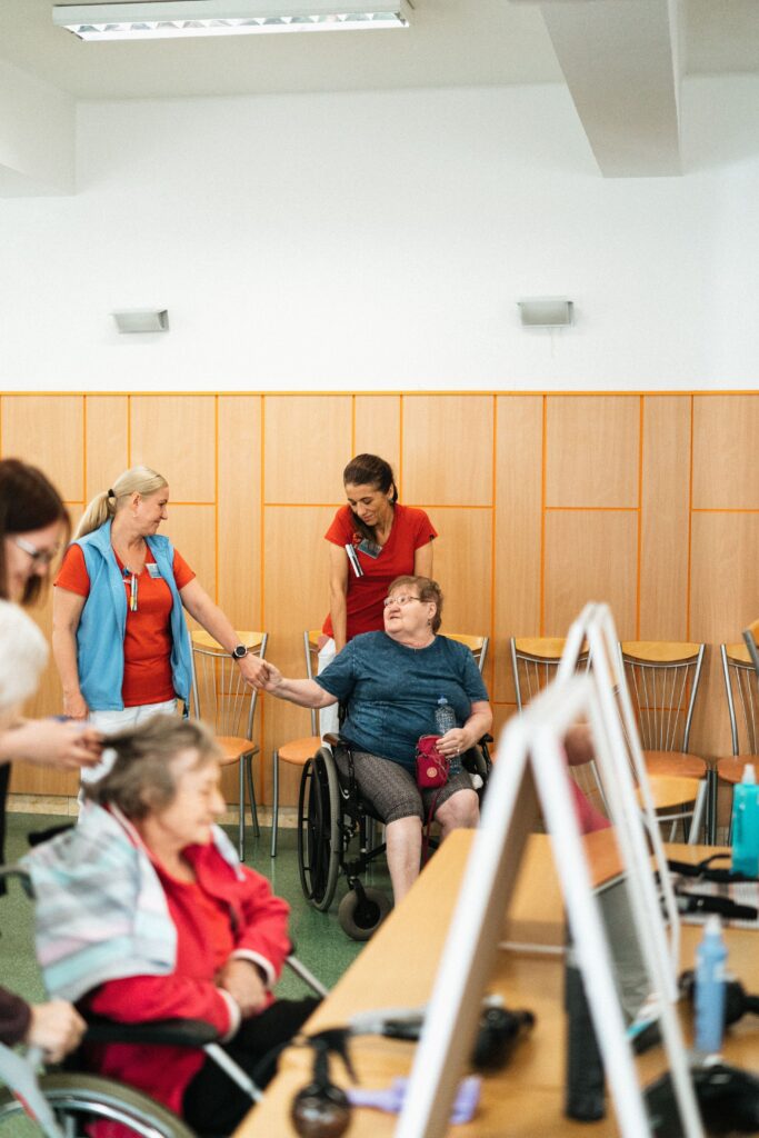 pexels photo 18429309 18429309 Healthcare professionals interact with elderly individuals in a care facility.