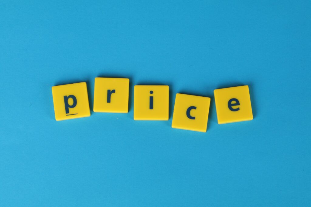 pexels photo 1888026 1888026 Yellow letter tiles spell the word 'price' against a vibrant blue backdrop, ideal for business concepts.
