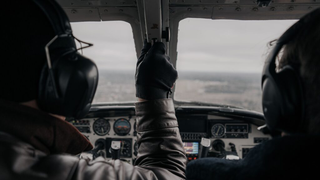 pexels photo 19086339 19086339 Two pilots operating a small aircraft from the cockpit with clear dashboard view.