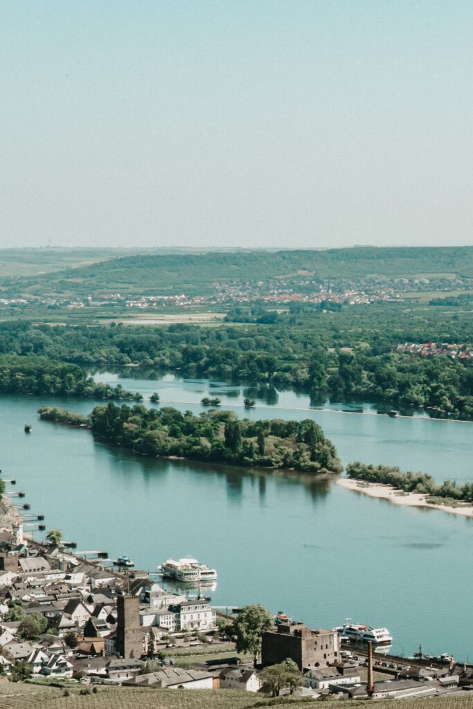 pexels photo 19429208 19429208 Scenic aerial view of Rüdesheim am Rhein with the Rhine River flowing through lush greenery and historic buildings.