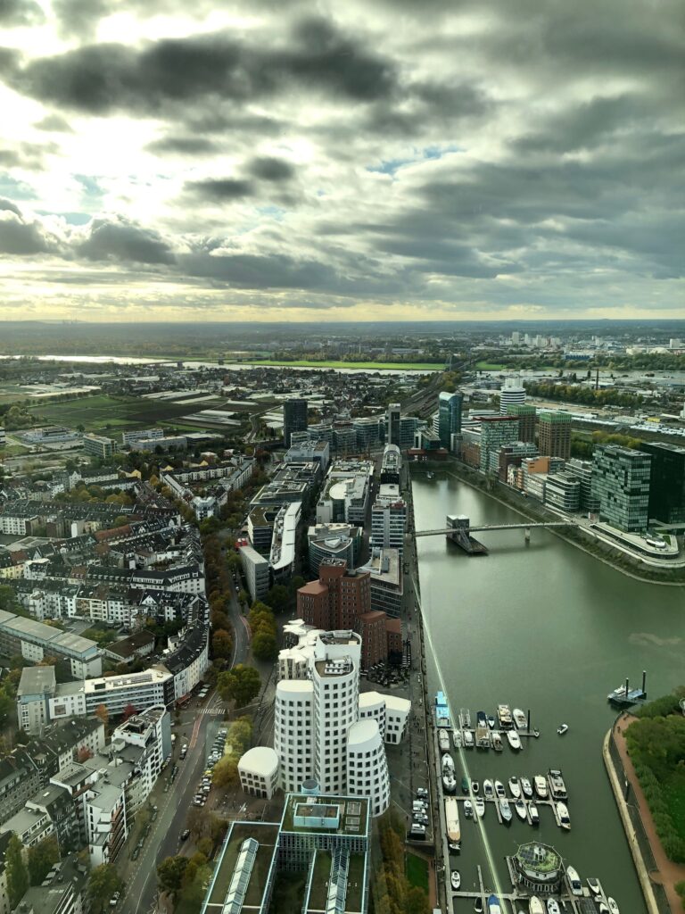 pexels photo 20509019 20509019 High-angle view of Düsseldorf's urban landscape and Rhine River on a cloudy day.