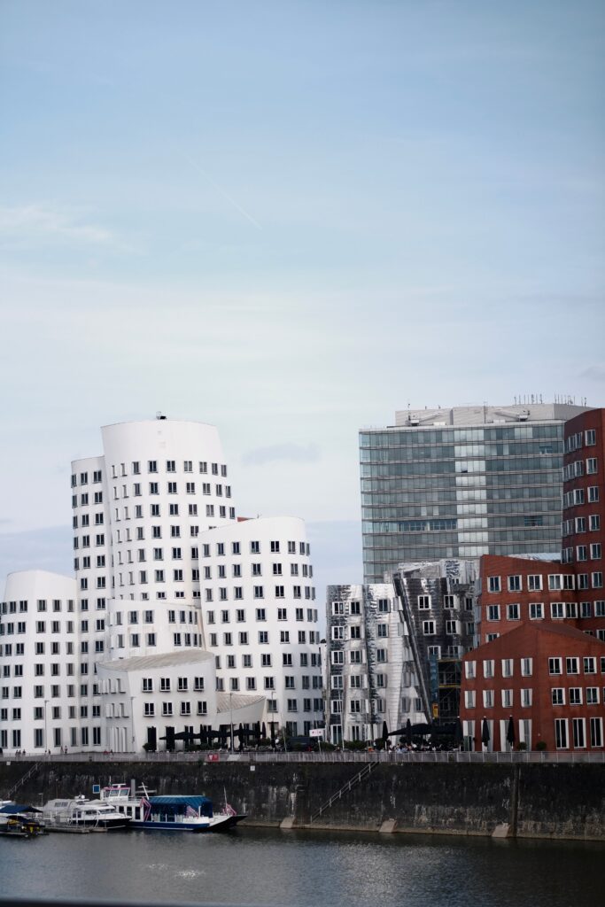 pexels photo 21624194 21624194 Modern buildings by the Rhine River in Düsseldorf, showcasing architectural innovation.