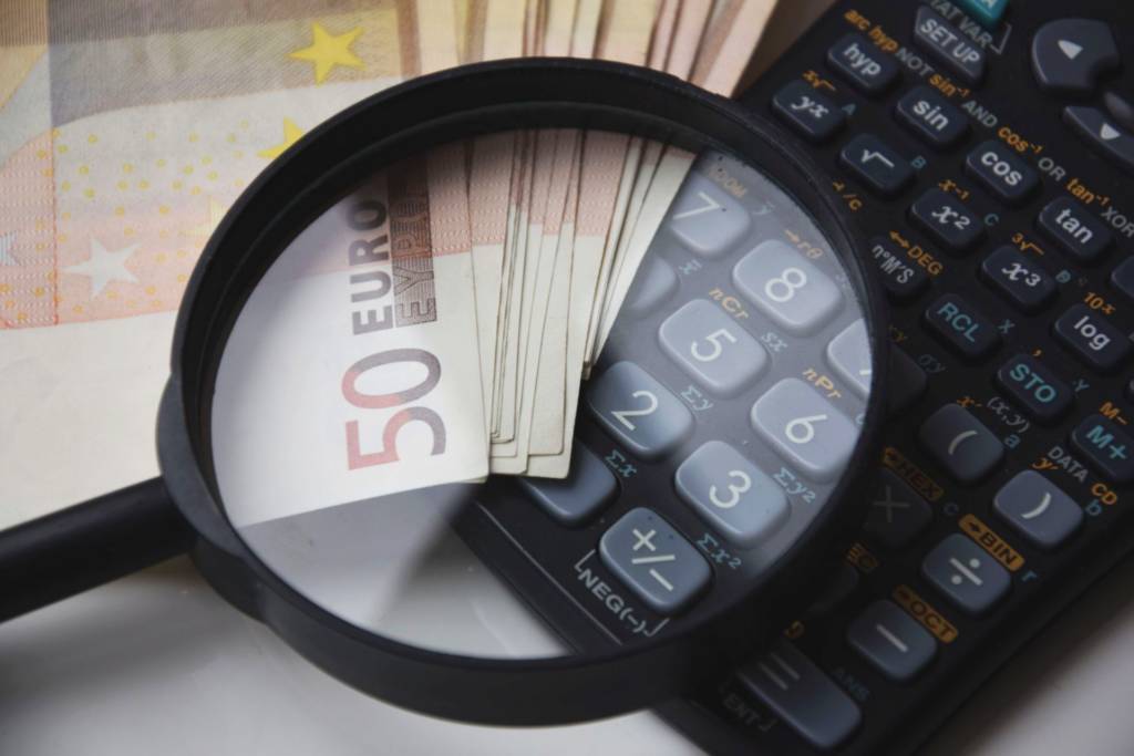 pexels photo 221174 221174 Euro bills under magnifying glass with calculator, symbolizing finance and analysis.