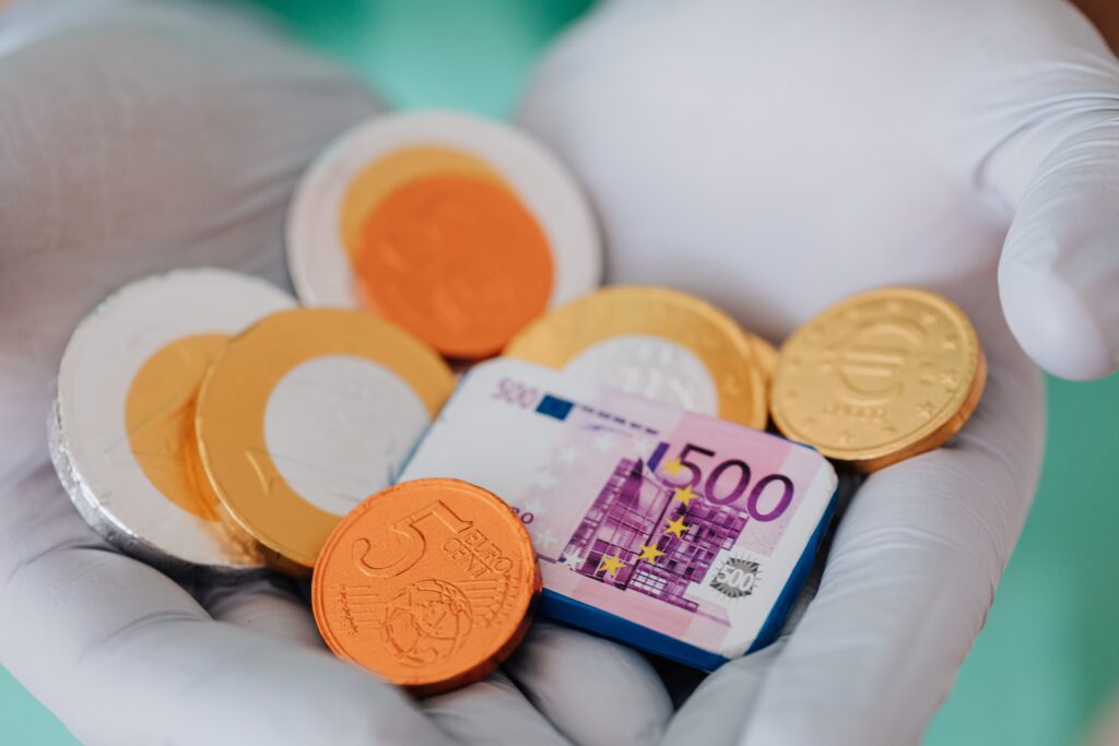 pexels photo 4021795 4021795 Unrecognizable medical practitioner demonstrating plastic money euro and coins in gloves in clinic while working and holding money wearing medical uniform