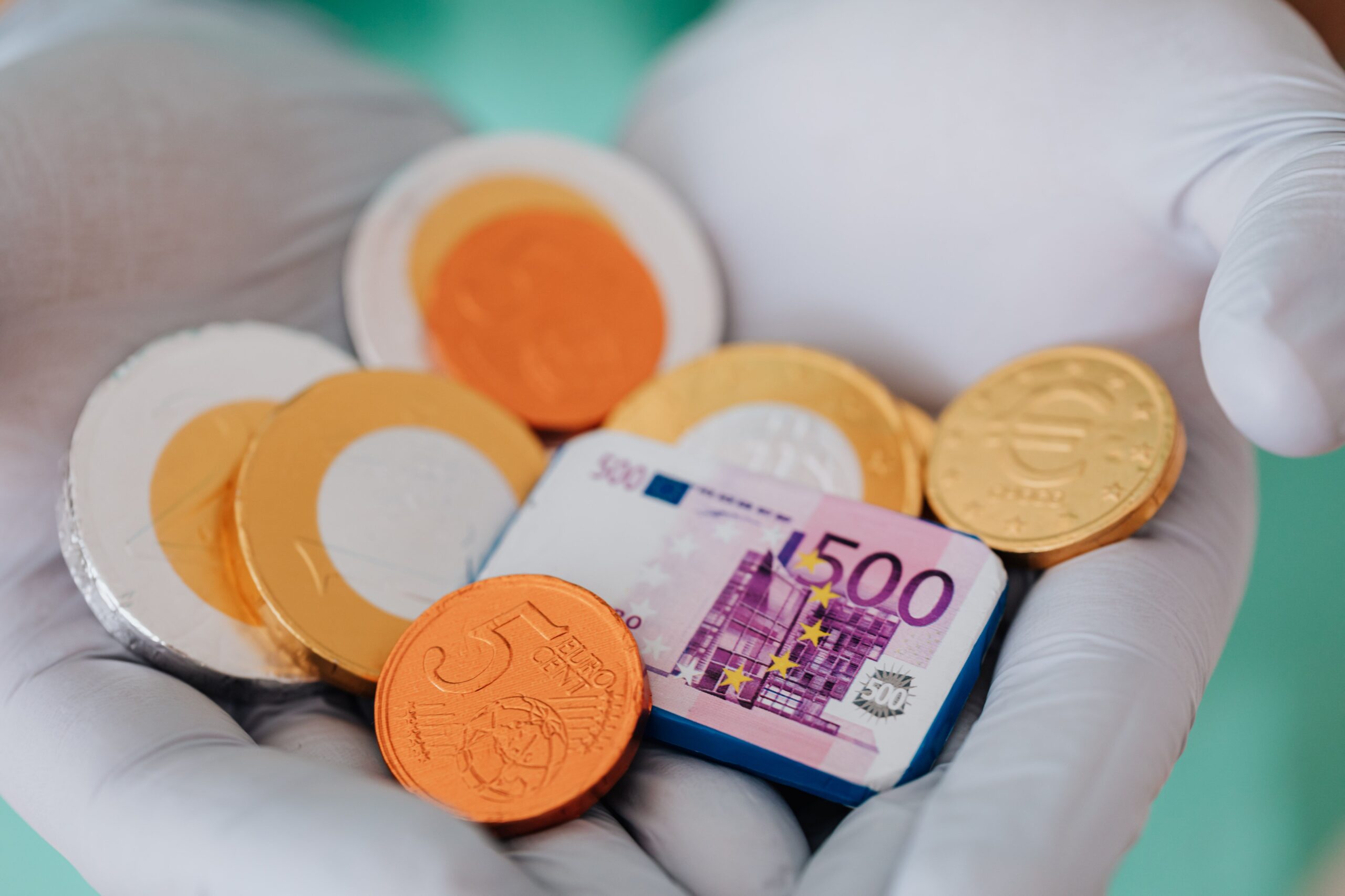 Treppenlift-Förderung im Saarland – Zuschüsse, Finanzierung und Fördermöglichkeiten im Überblick Unrecognizable medical practitioner demonstrating plastic money euro and coins in gloves in clinic while working and holding money wearing medical uniform