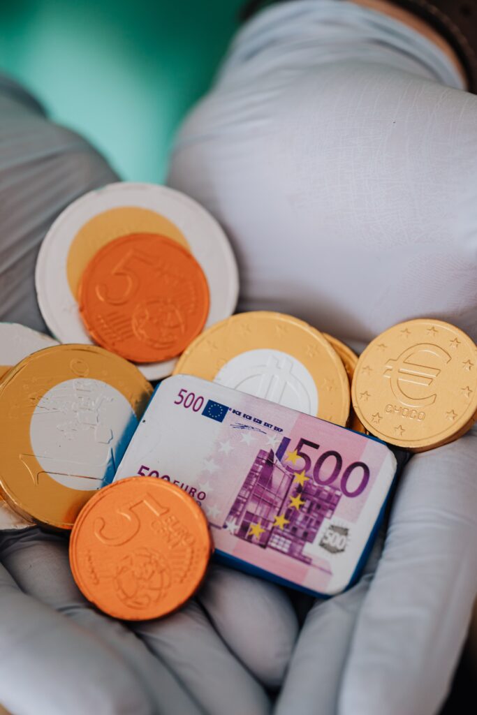 pexels photo 4021807 4021807 Unrecognizable person demonstrating coins and plastic euro wearing latex gloves during pandemic in modern clinic showing salary of medical workers