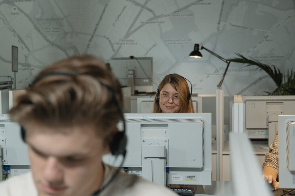 pexels photo 5453812 5453812 Call center employees working with computers and headsets, providing customer support.