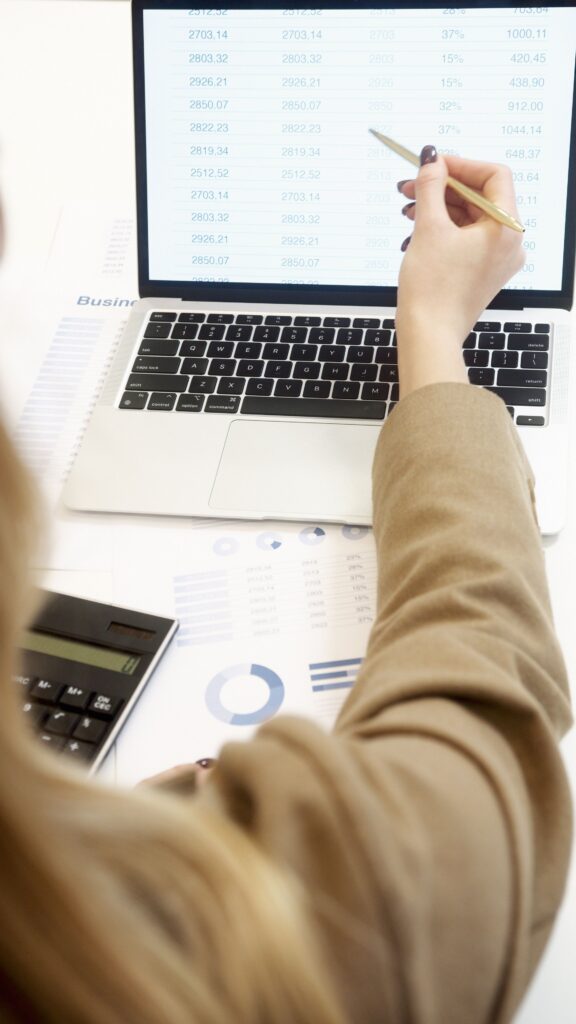 Business professional analyzing financial data on a laptop for strategic decision making.