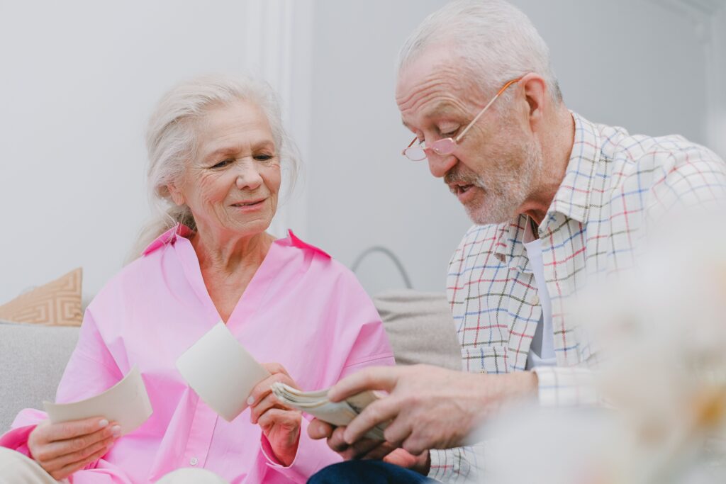 pexels photo 7545252 7545252 Senior couple enjoying time together while looking at photographs, smiling and reminiscing.