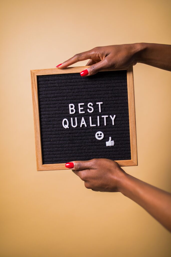pexels photo 7564203 7564203 Hands holding a letter board with 'Best Quality' text, emoji, and thumbs up.