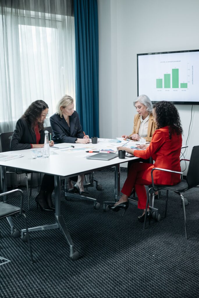 pexels photo 8424528 8424528 Businesswomen collaborating around a table in a modern office for a meeting.