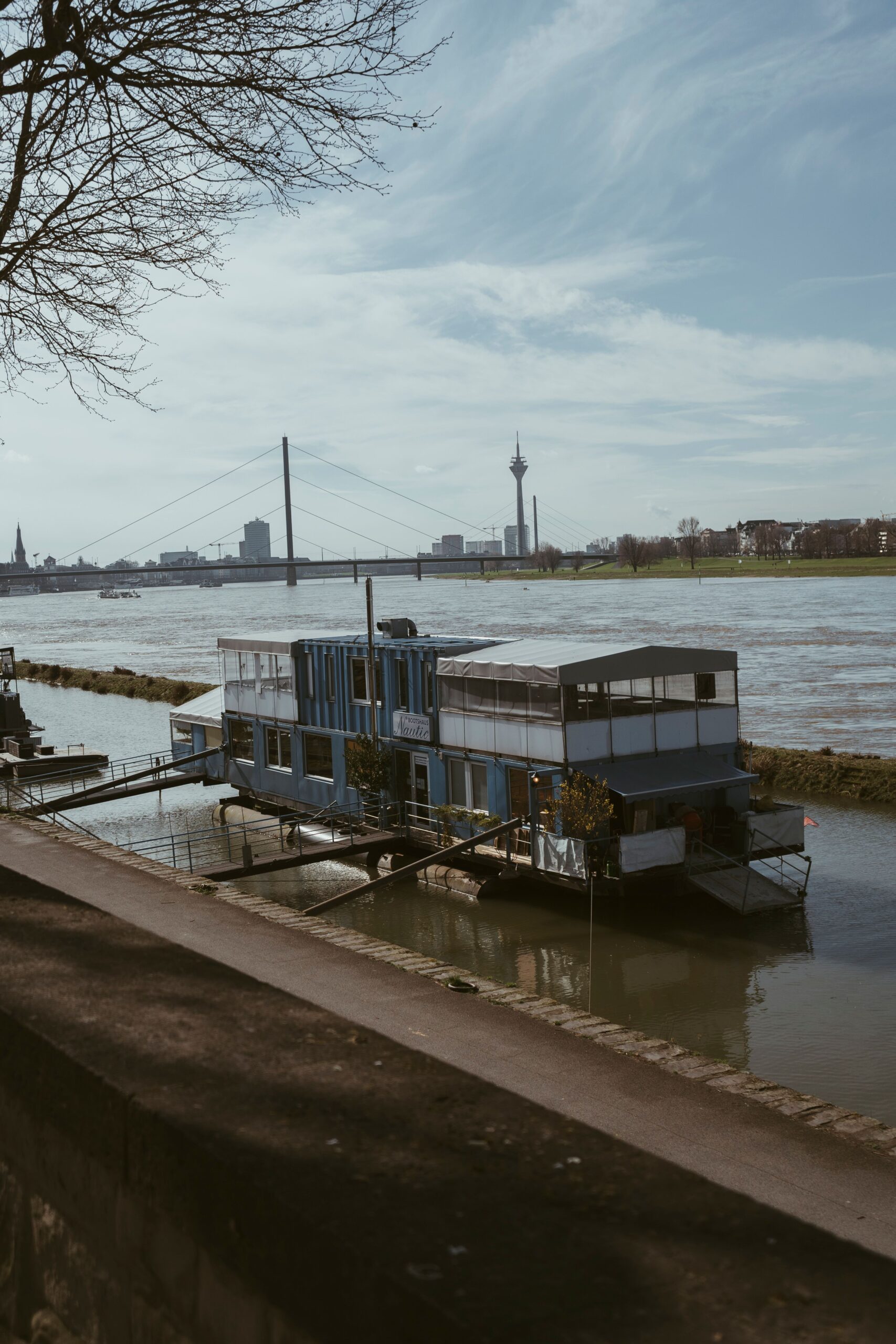 Düsseldorf cityscape featuring the Rhine River and iconic bridge, perfect for travel themes.