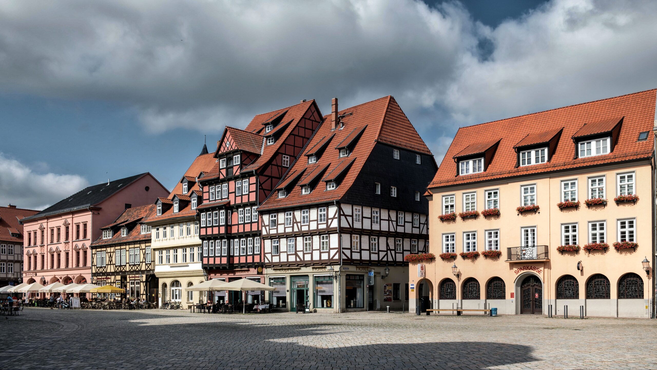 Explore the charming historic architecture of Quedlinburg's old town square with half-timbered houses.