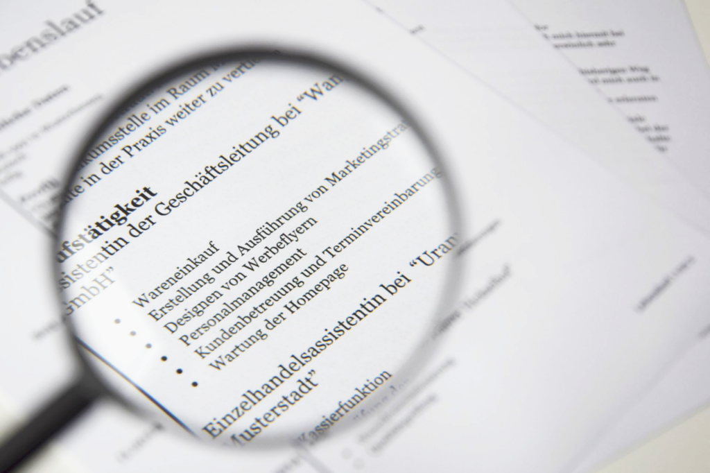 Treppenlift Pilot Close-up of a business document text under a magnifying glass.