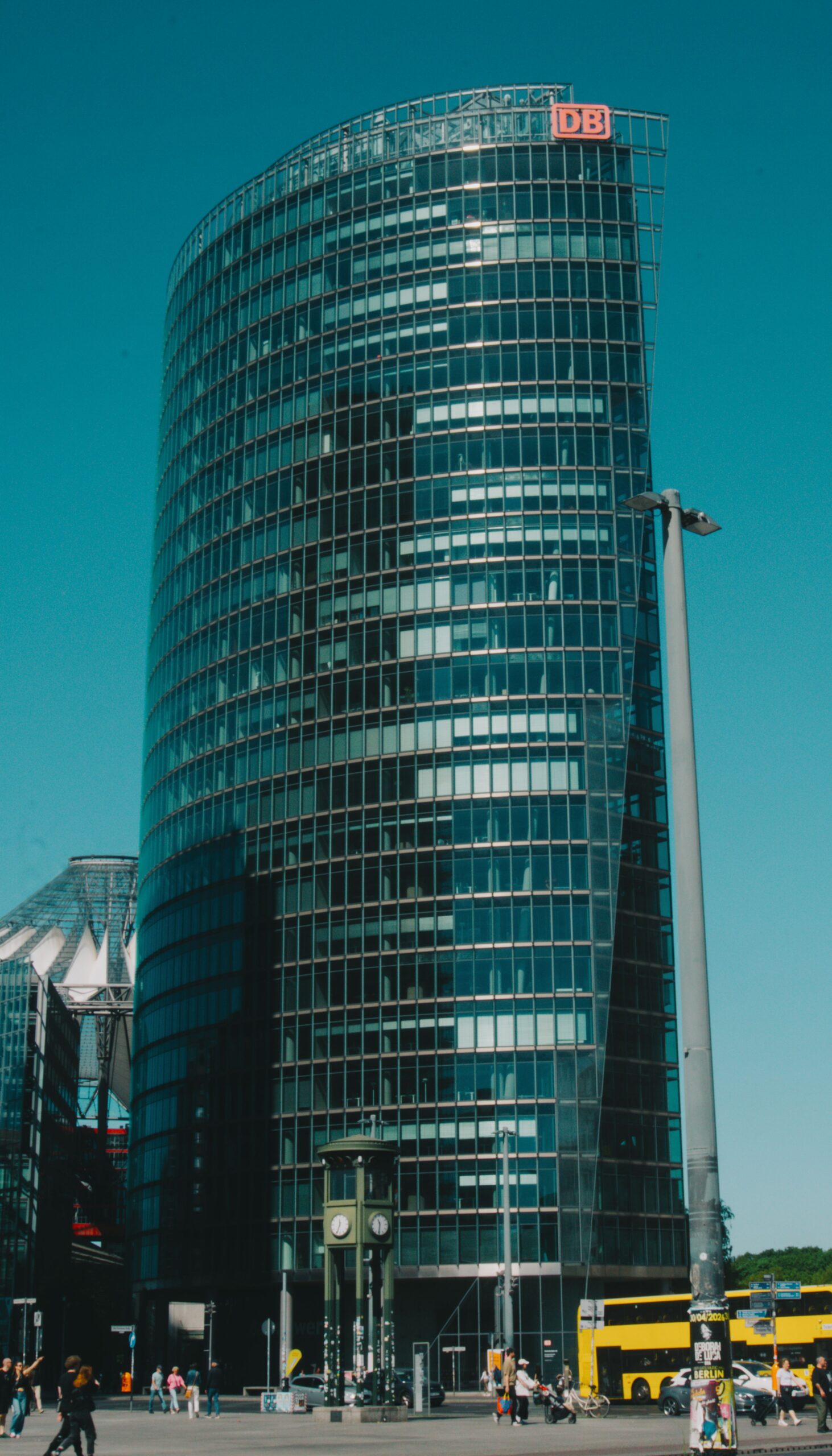 Contemporary glass skyscraper in Berlin, showcasing modern architecture at Potsdamer Platz on a sunny day.